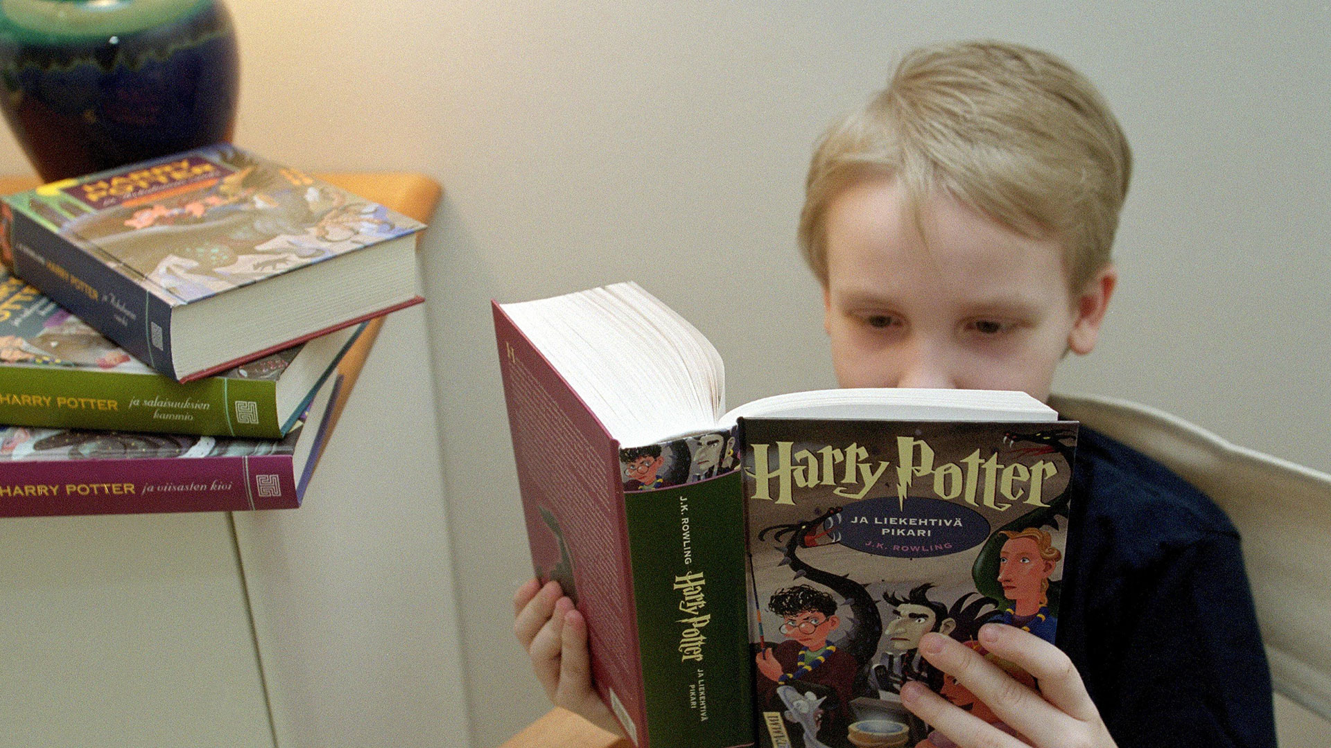 Child reading Harry Potter book