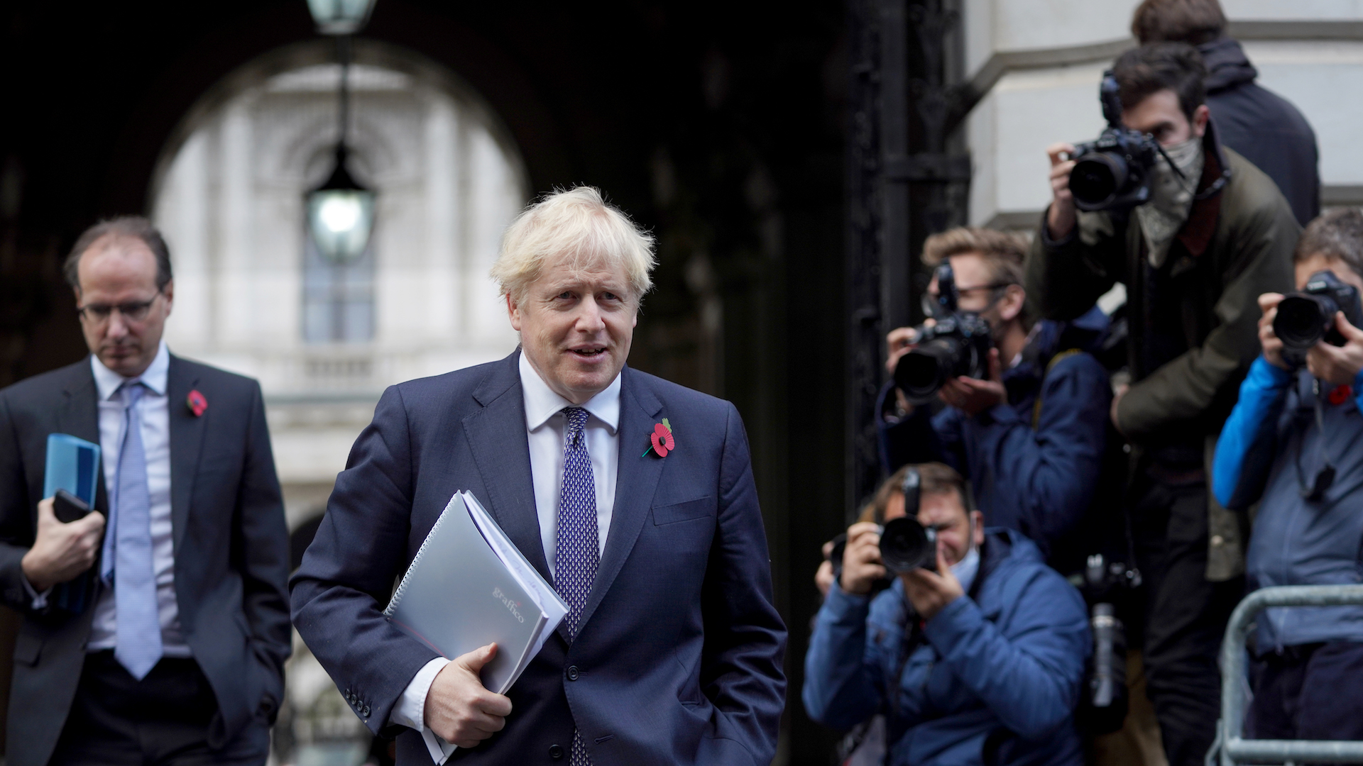 Prime Minister Boris Johnson walks through Whitehall with papers under his arm