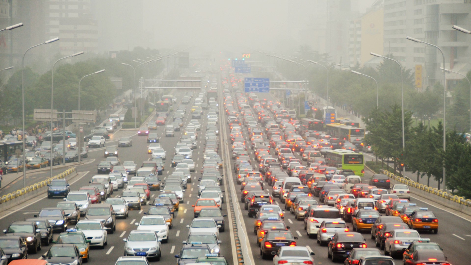 Traffic and pollution fill the streets of a round in Beijing