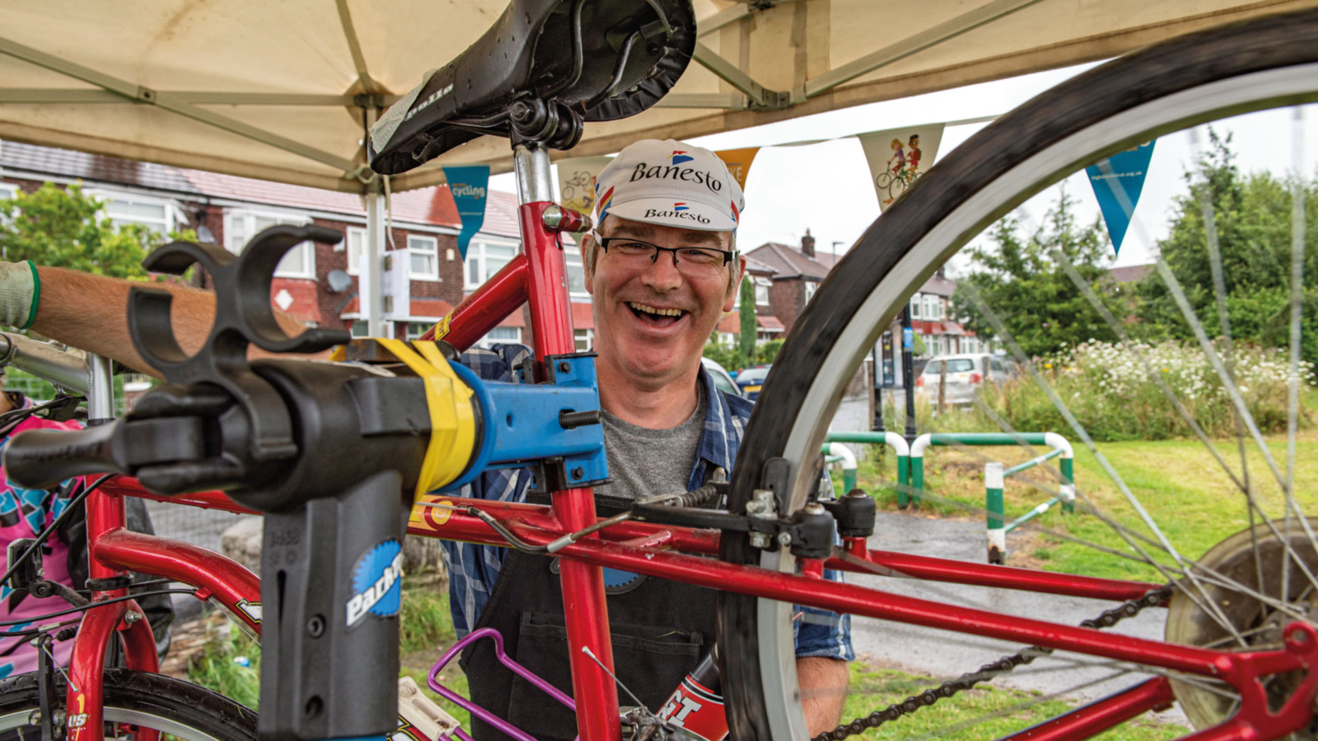 A mechanic with Cycling UK works on a bike