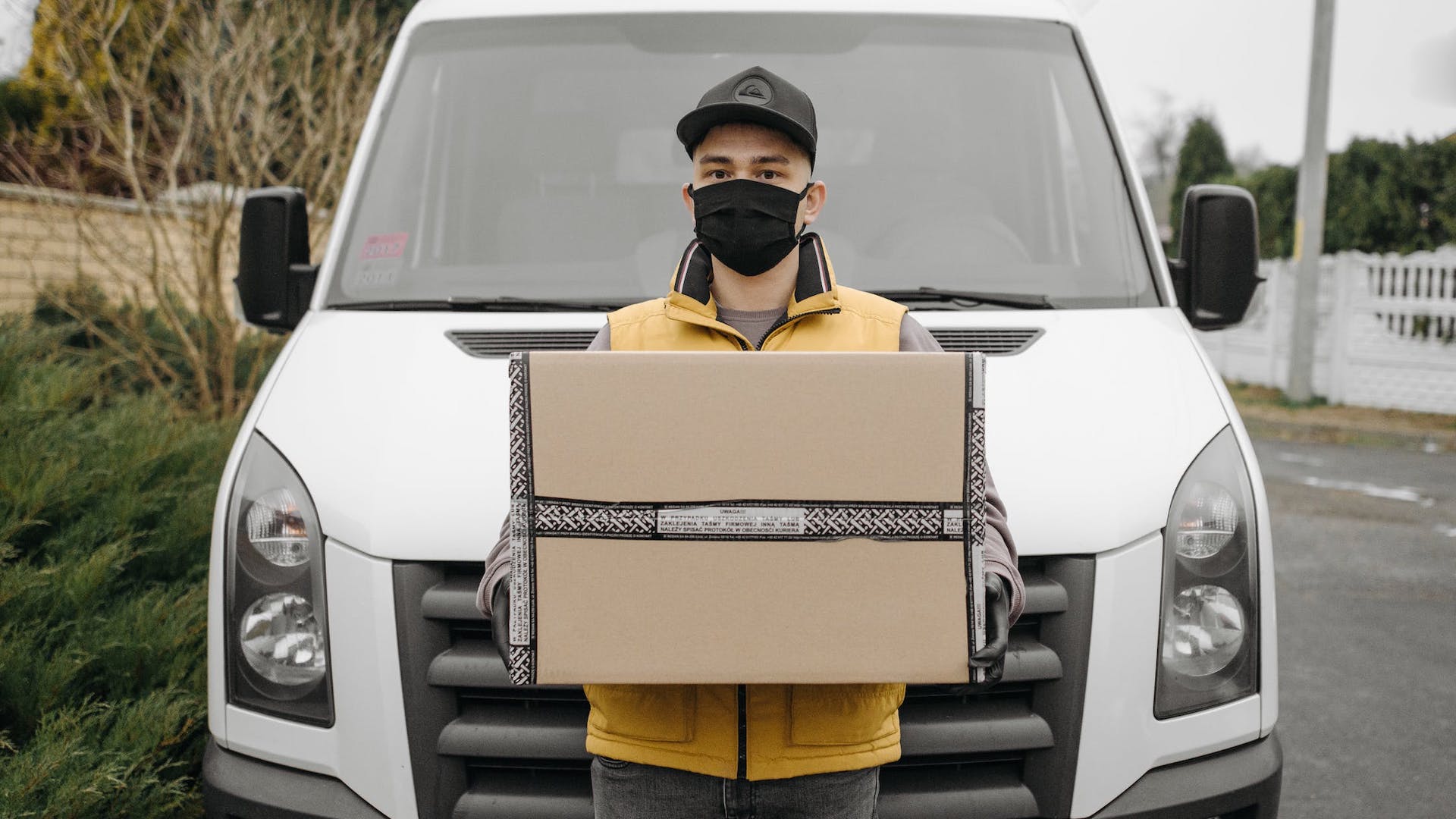 Gig economy courier standing outside van