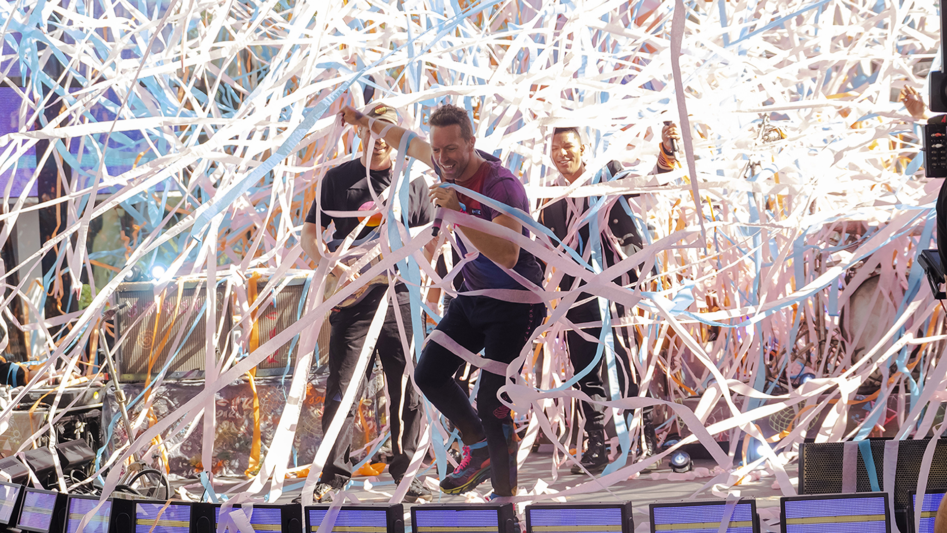 Coldplay singer Chris Martin performs surrounded by streamers