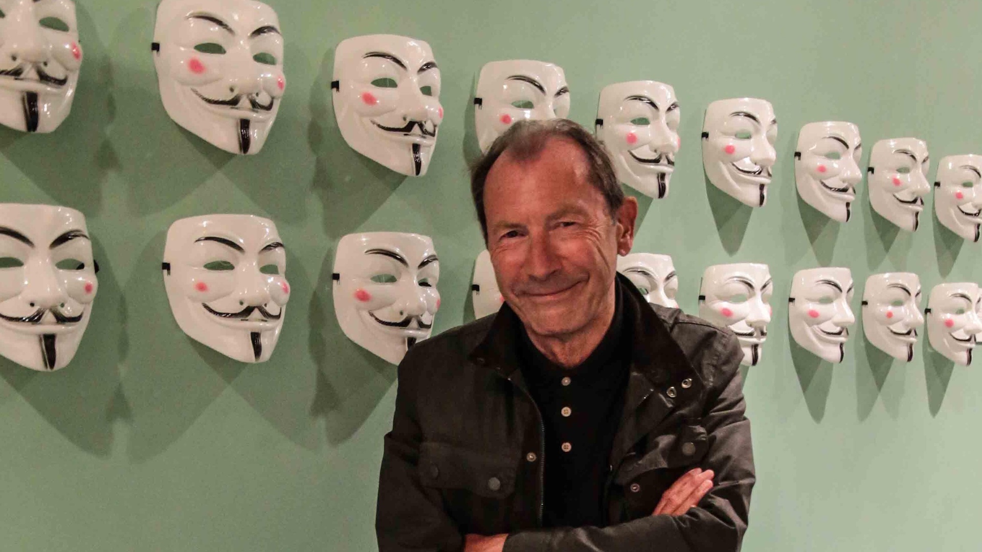 Artist David Lloyd. stands in front of the V for Vendetta masks he originally designed which became an emblem for the Occupy movement.