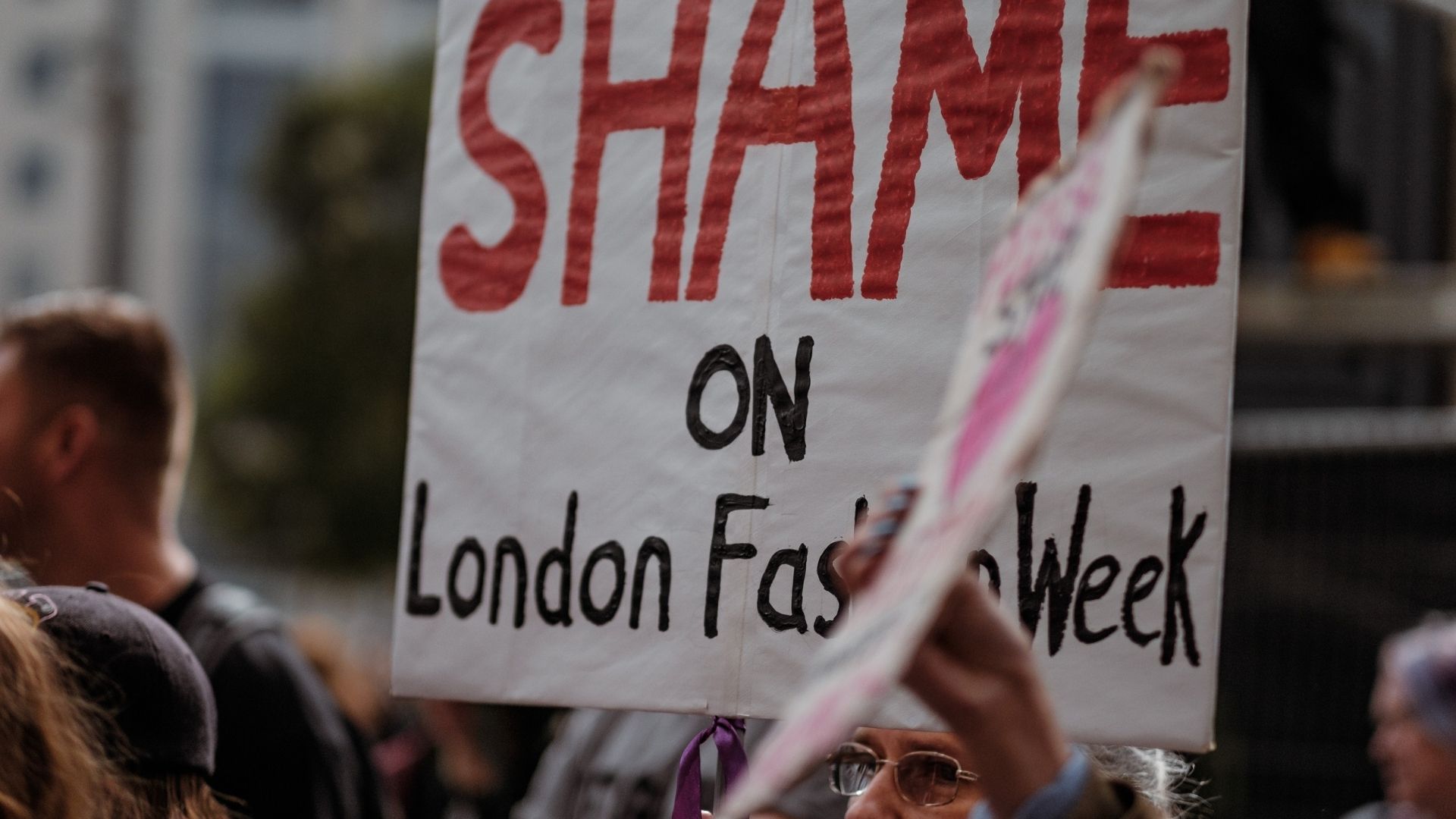 Shame poster held at London Fashion Week