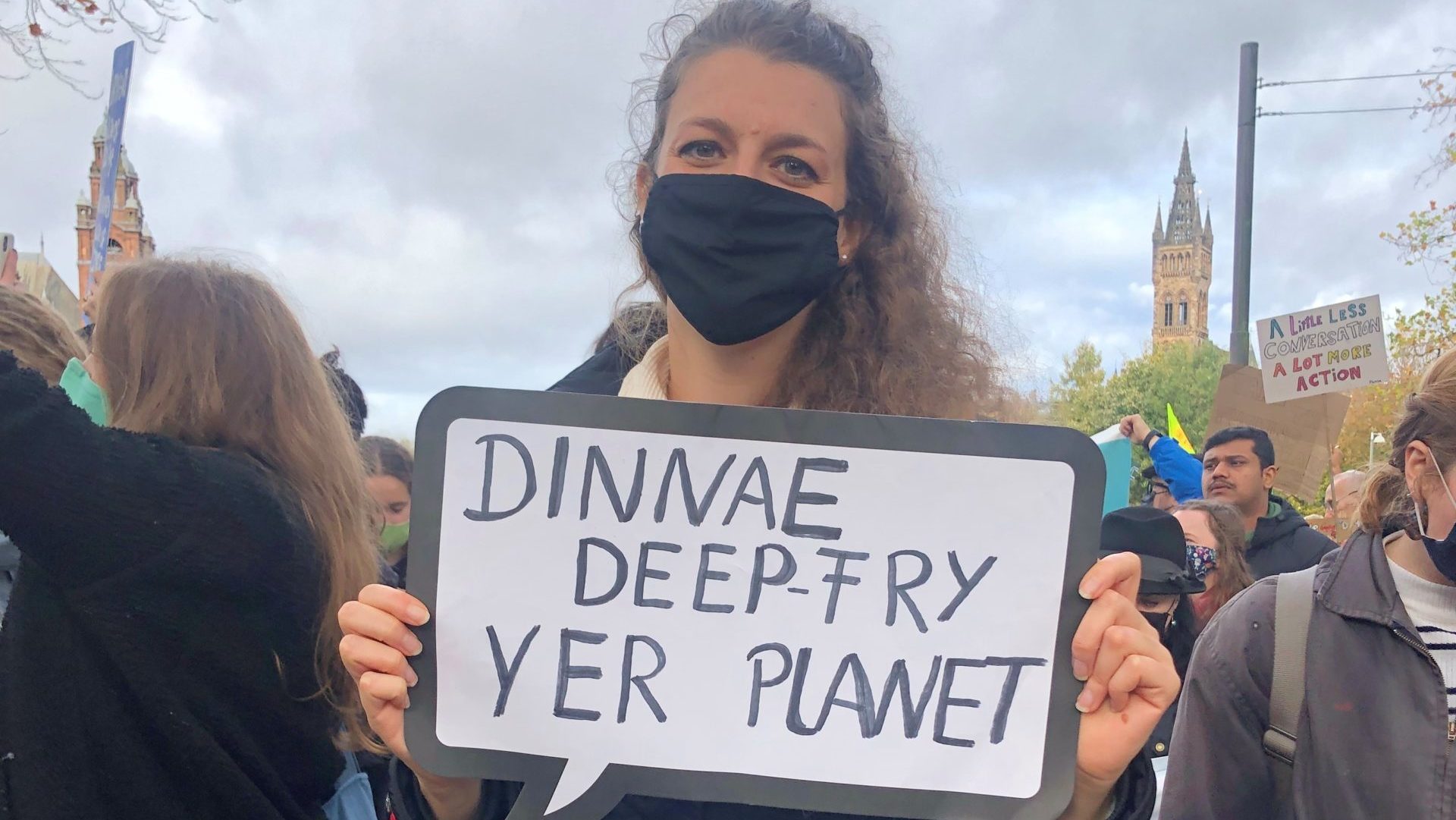 A protester on the youth climate strike with a sign reading "dinnae deep-fry yer planet". Image: Sarah Wilson