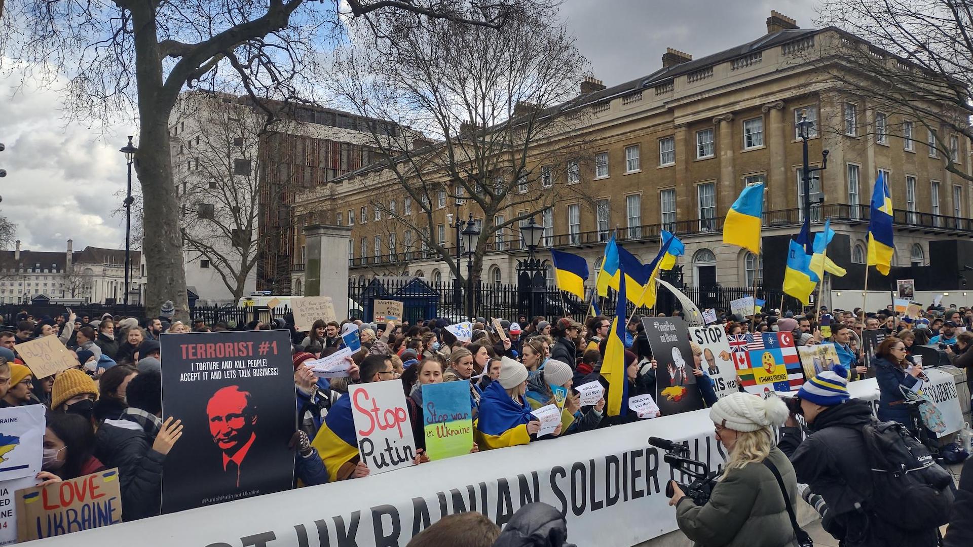 Blue and yellow Ukrainian flags fly outside Downing Street as hundreds protest the invasion by Russia