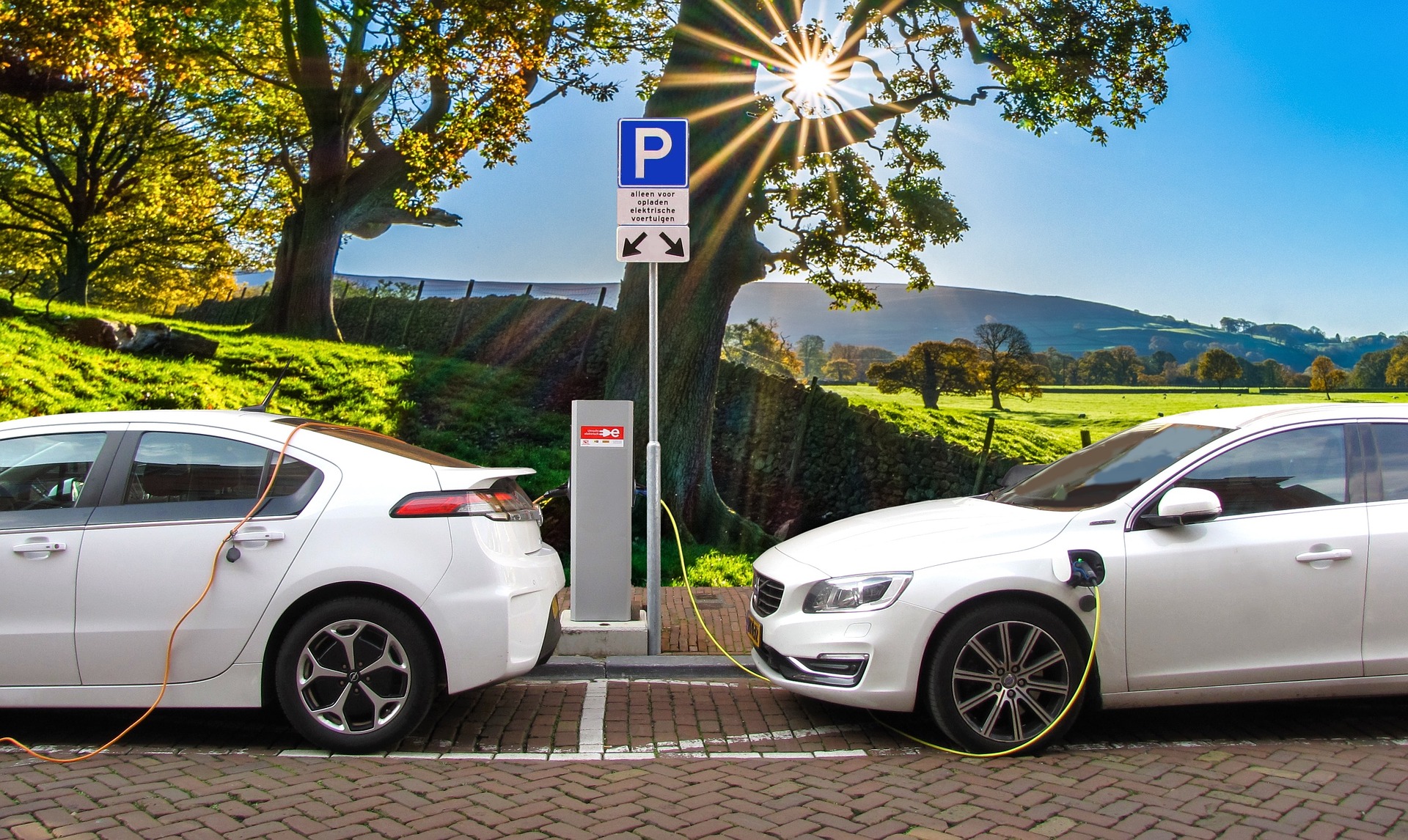 Two electric cars plugged into charging points