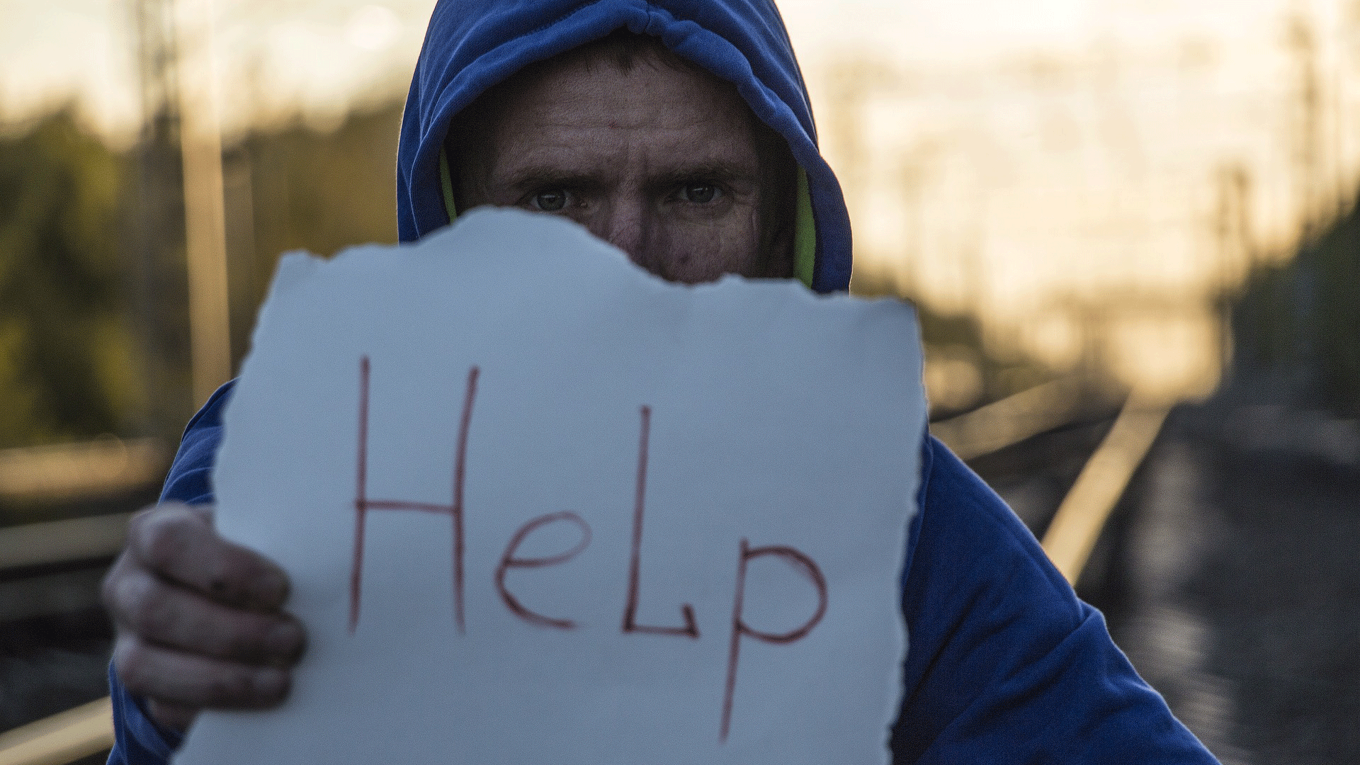 man holding help sign