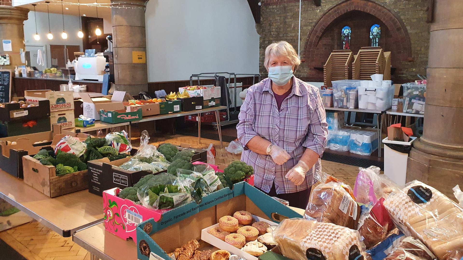 A volunteer at Earlsfield food bank sorts fresh food for guests to cook