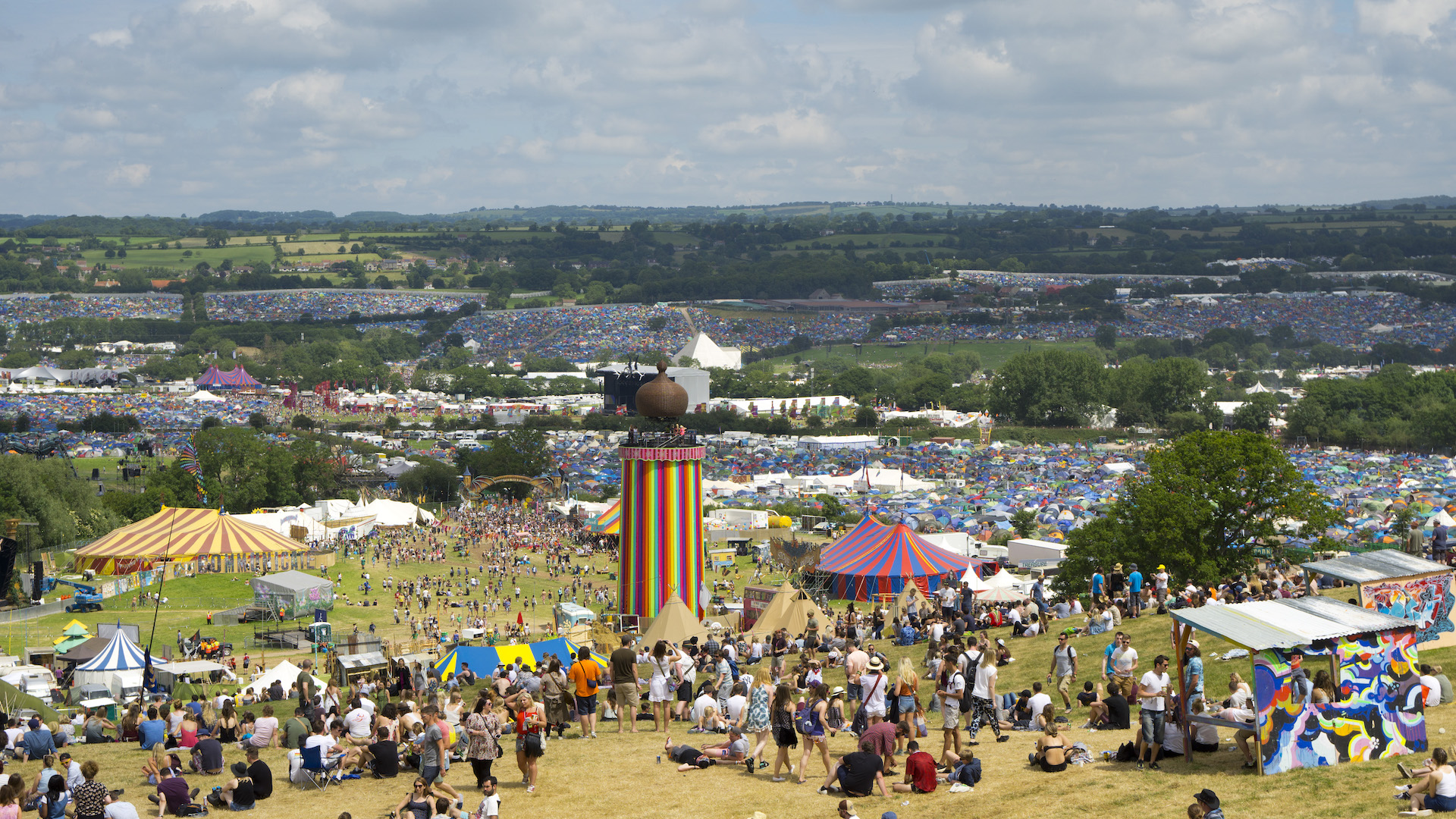 Thousands of people and tents sptretch across the fields of Glastonbury festival