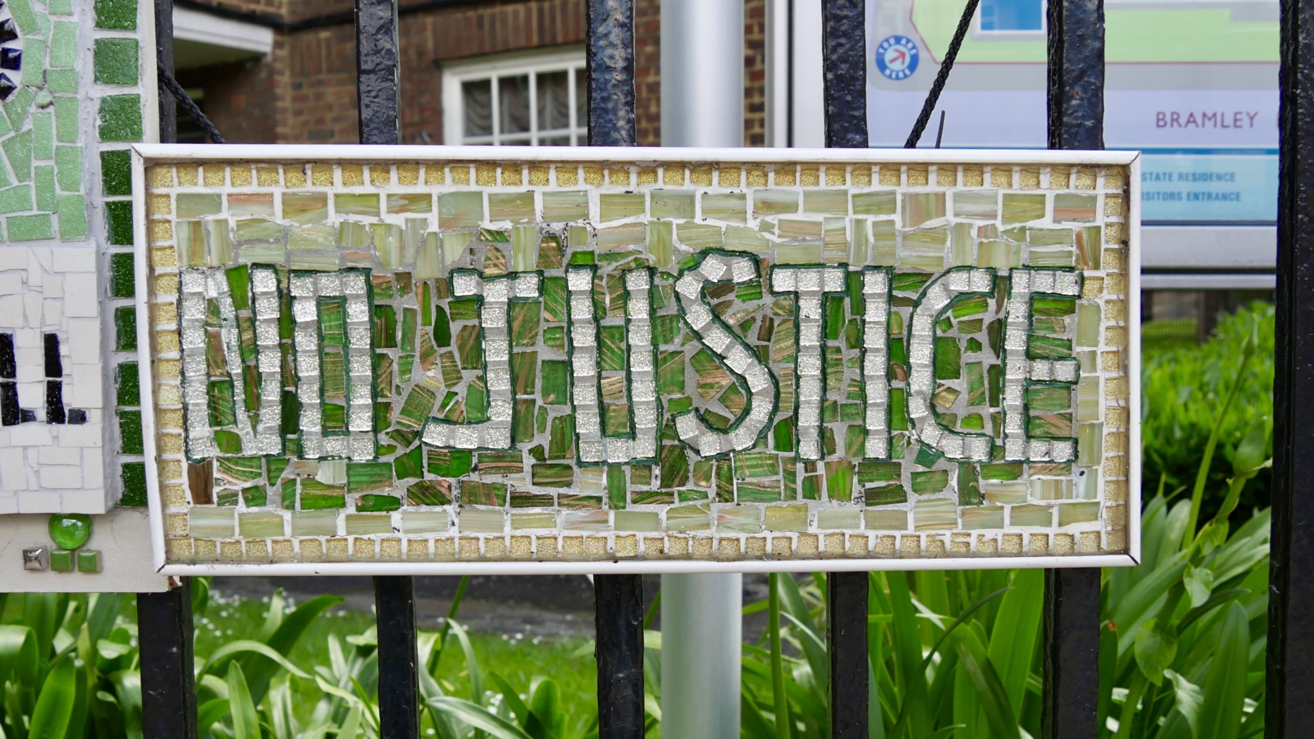 A mosaic sign that reads 'No Justice' in remembrance of Grenfell Tower