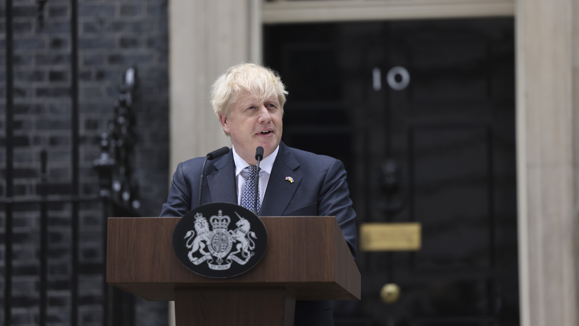Boris Johnson stands at the podium outside downing street with the famous door in the background