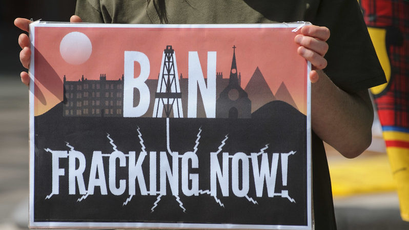 A protest sign reading: "ban fracking now".