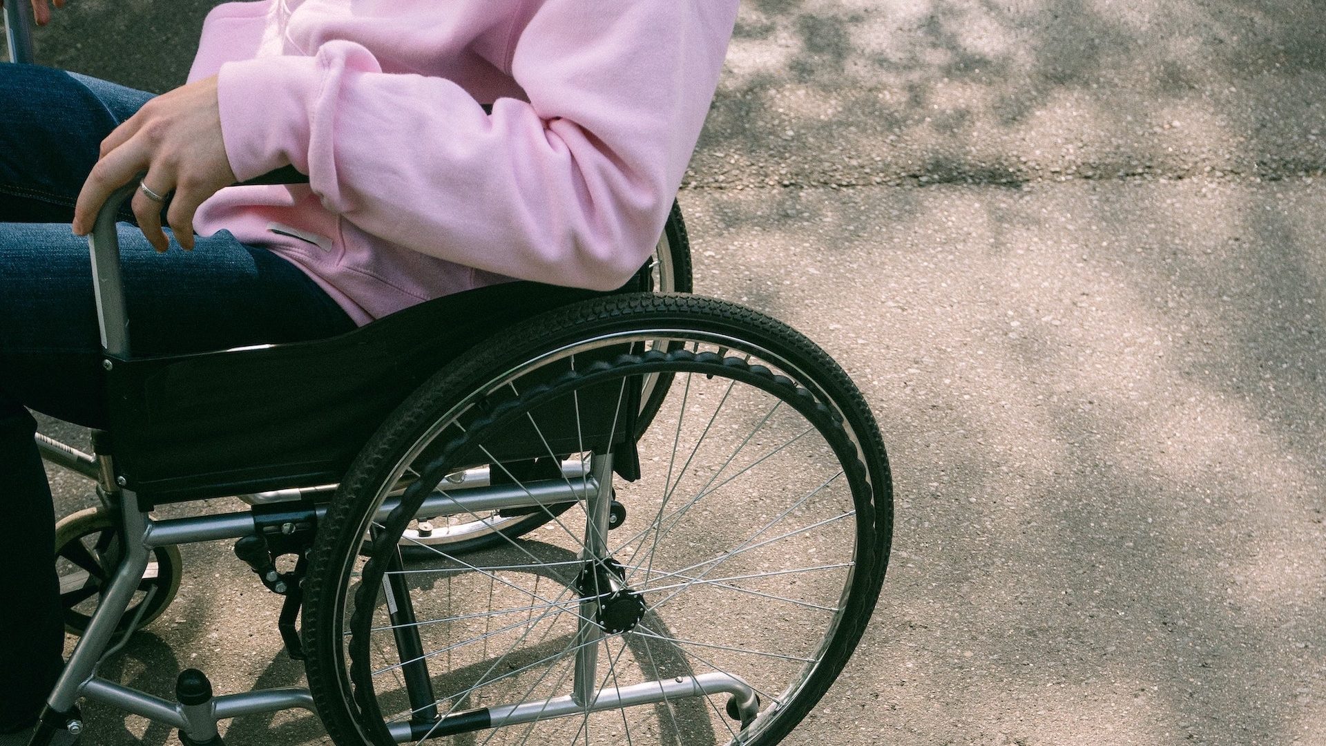 Image of person in wheelchair/ Disability cost of living payment