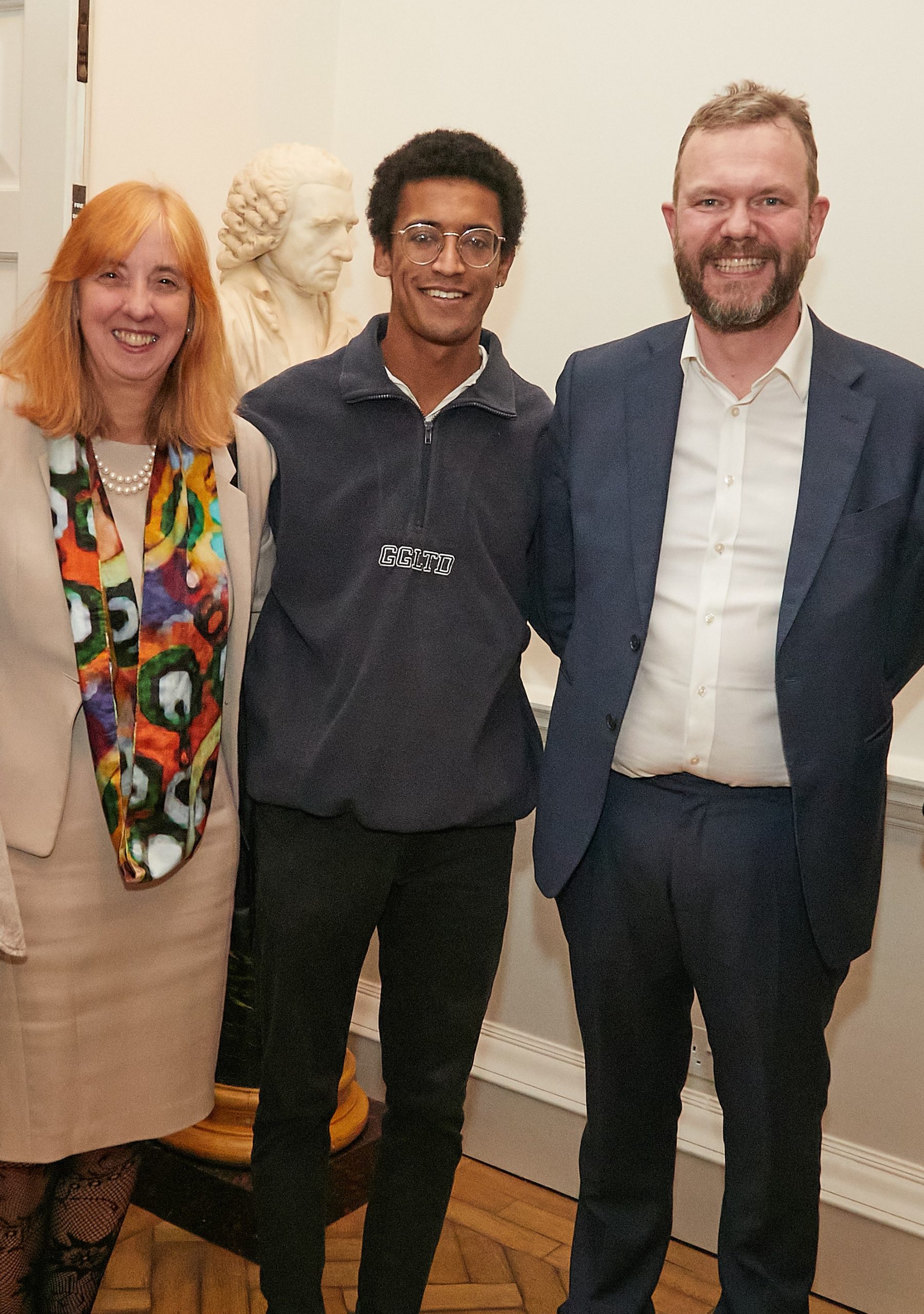 Anthony Lynch was adopted through Coram. He's pictured at an event to celebrate their 50th anniversary with James O'Brien and Coram CEO Dr Carol Homden. Image: Coram
