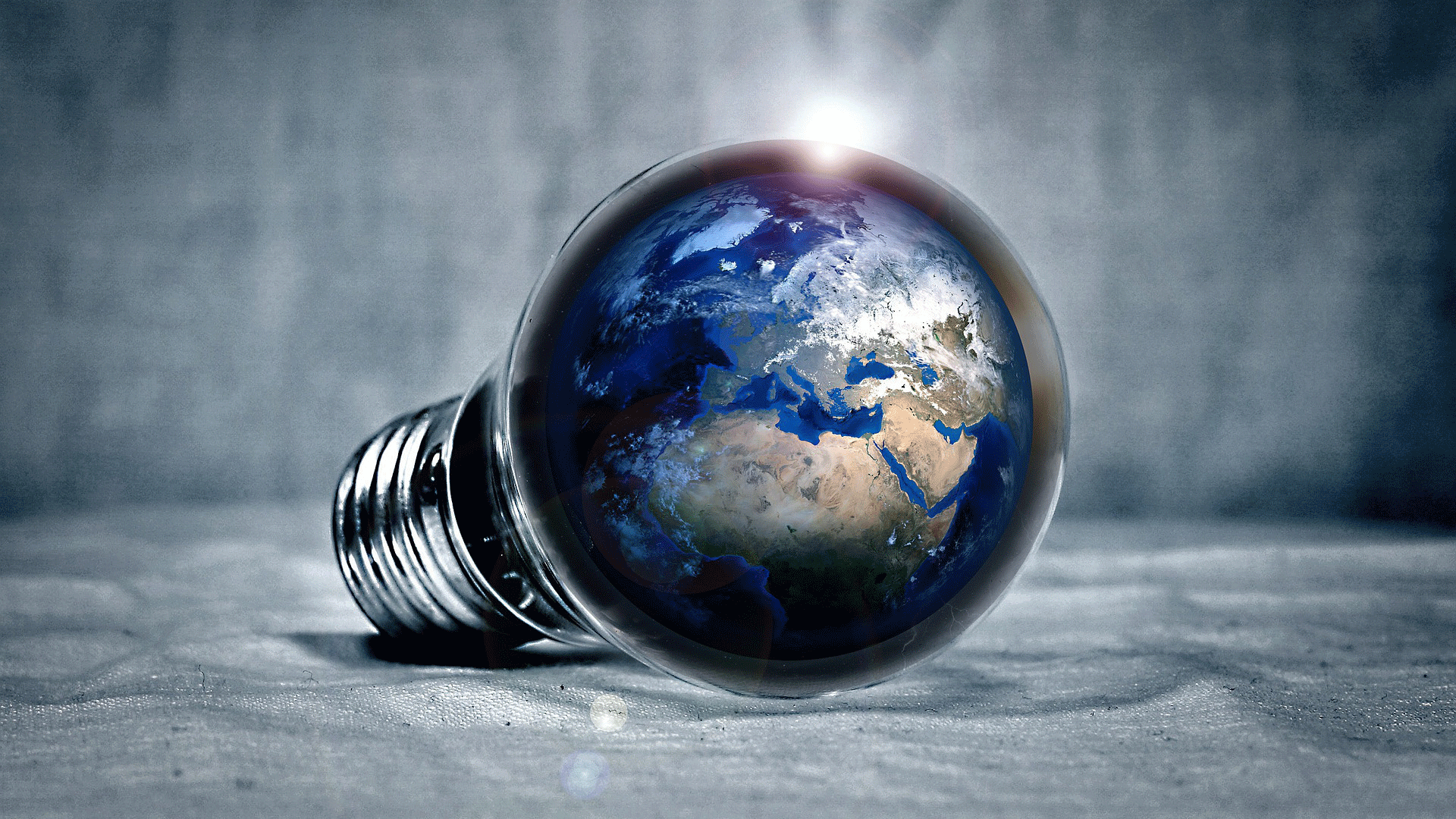 Planet earth reflected in a light bulb