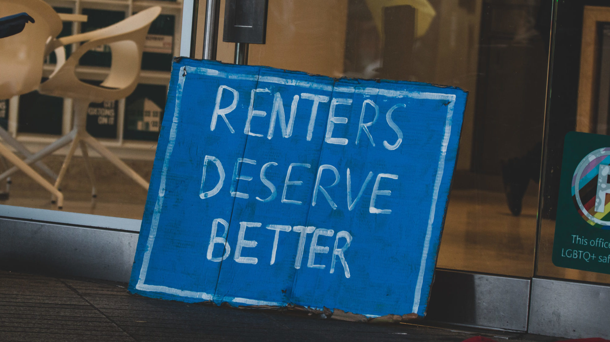 A sign saying "renters deserve better" at a rent freeze protest in London