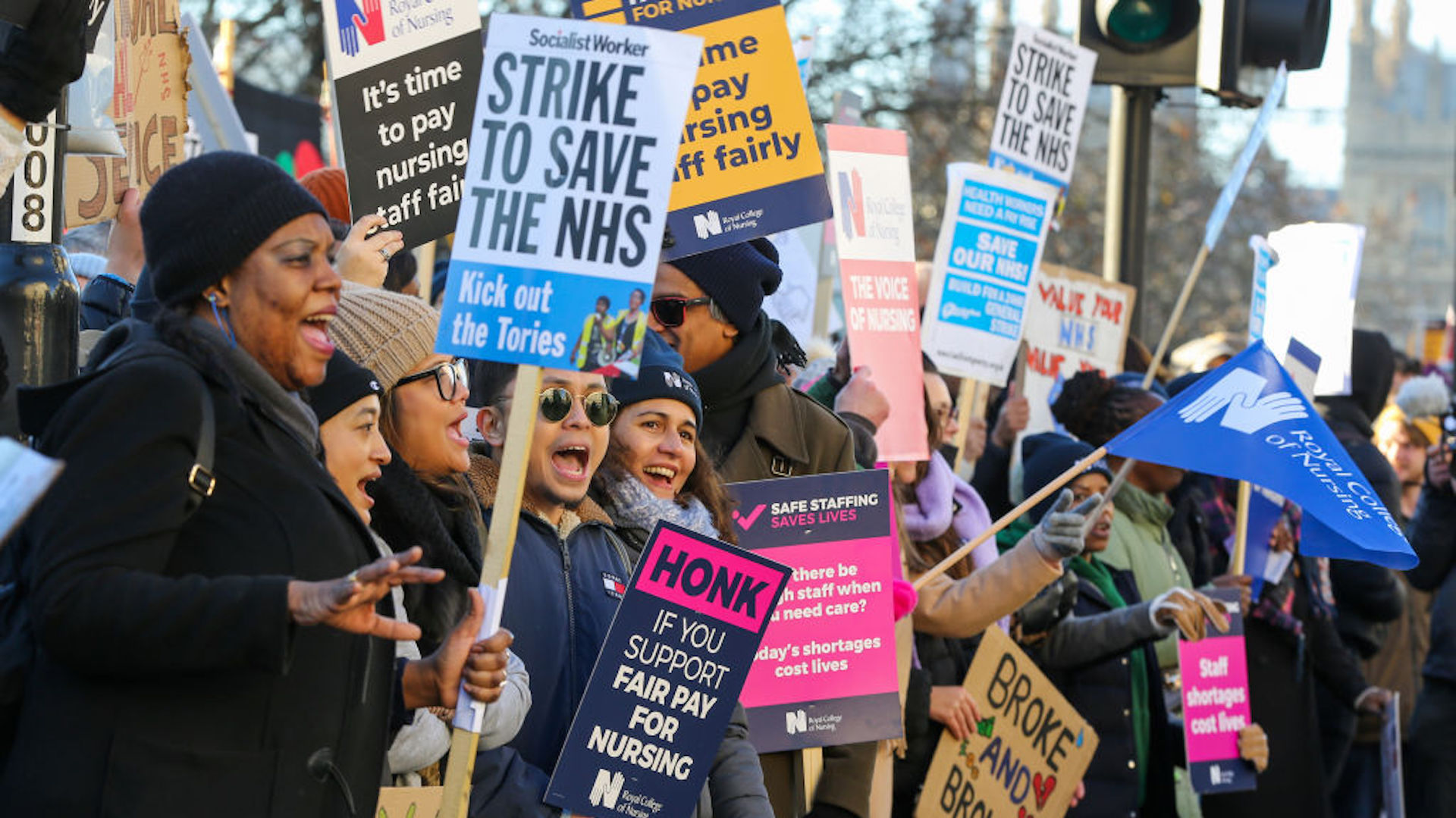 NHS nurses hold placards expressing their opinion during a protest outside St. Thomas' Hospital in central London on day one of the two strikes taking place this month.