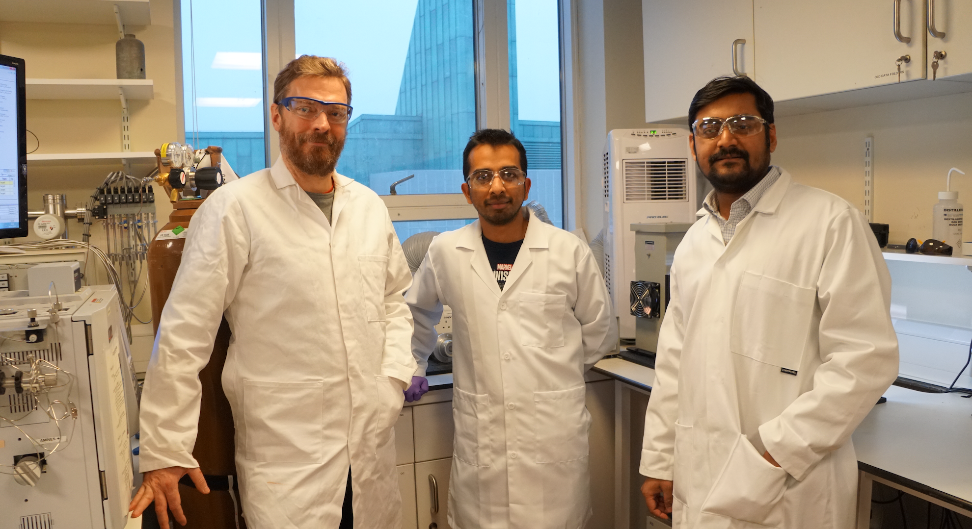 (Left to right) researchers Erwin Reisner, Subhajit Bhattacharjee, Motiar Rahaman standing in a lab with their sustainable fuel reactor