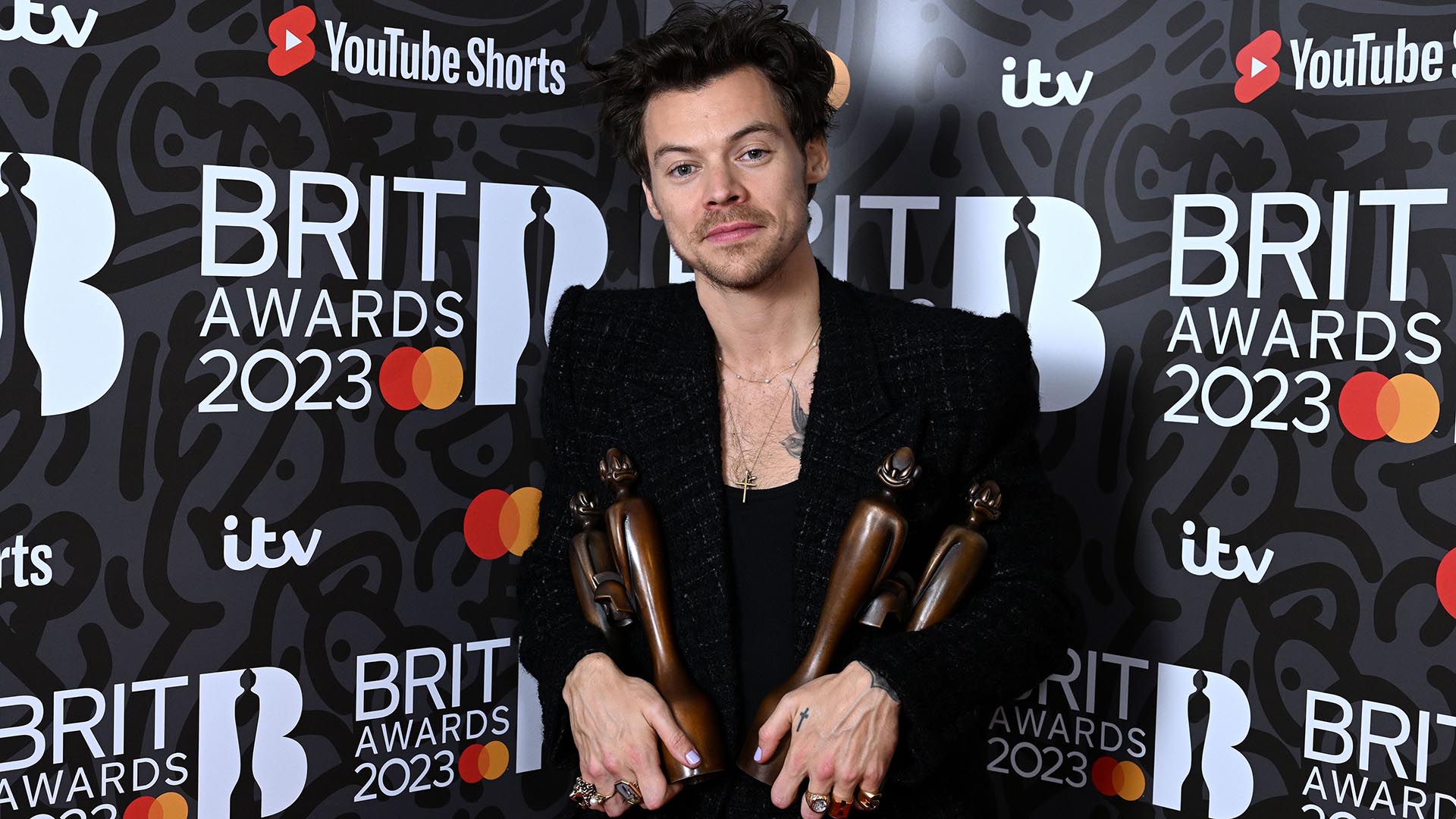 Harry Styles enjoys his awards at the 43rd BRIT Awards 2023. Image: Anthony Harvey/ Shutterstock