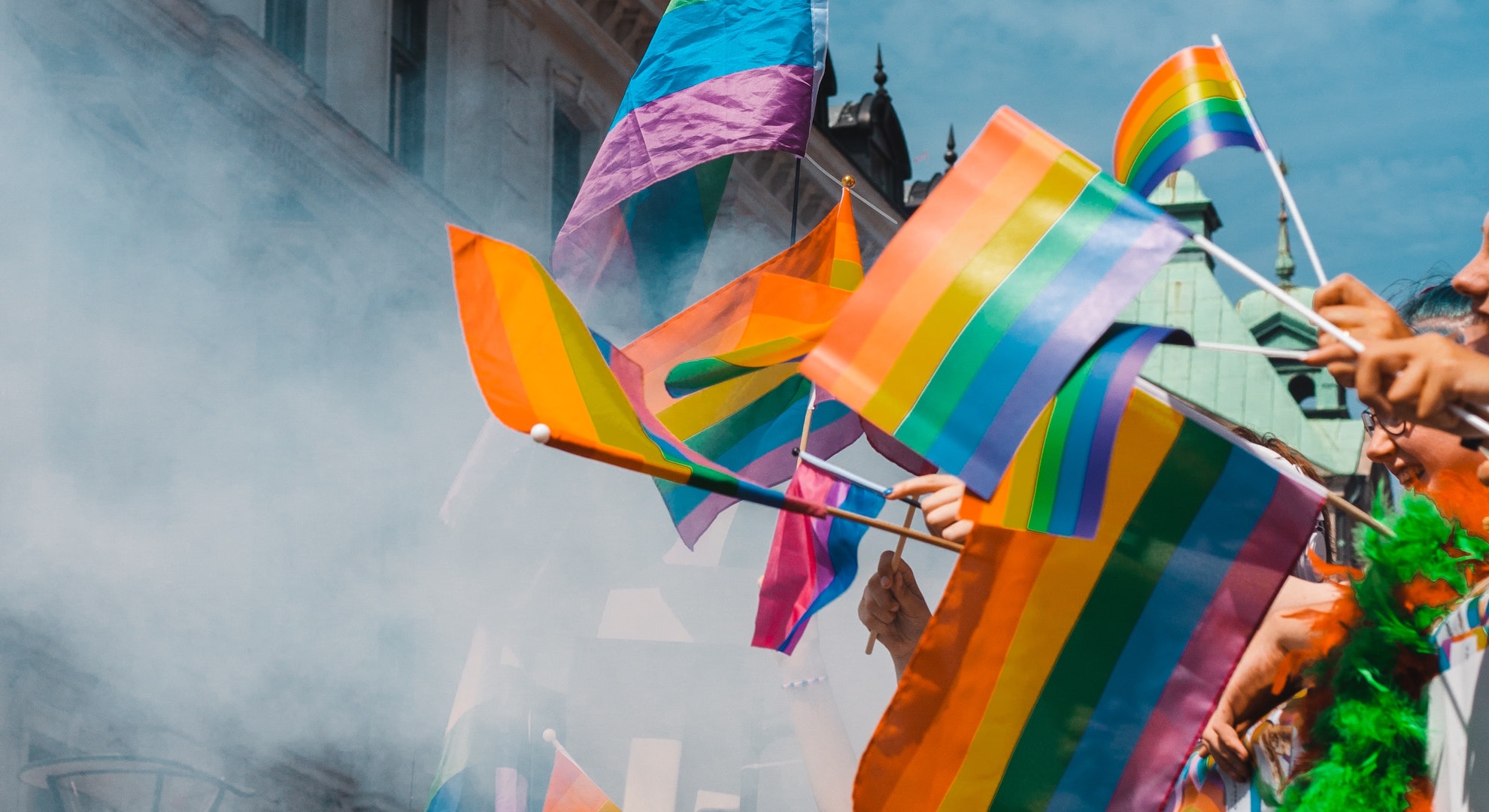 pride flags being waved at a Pride celebration
