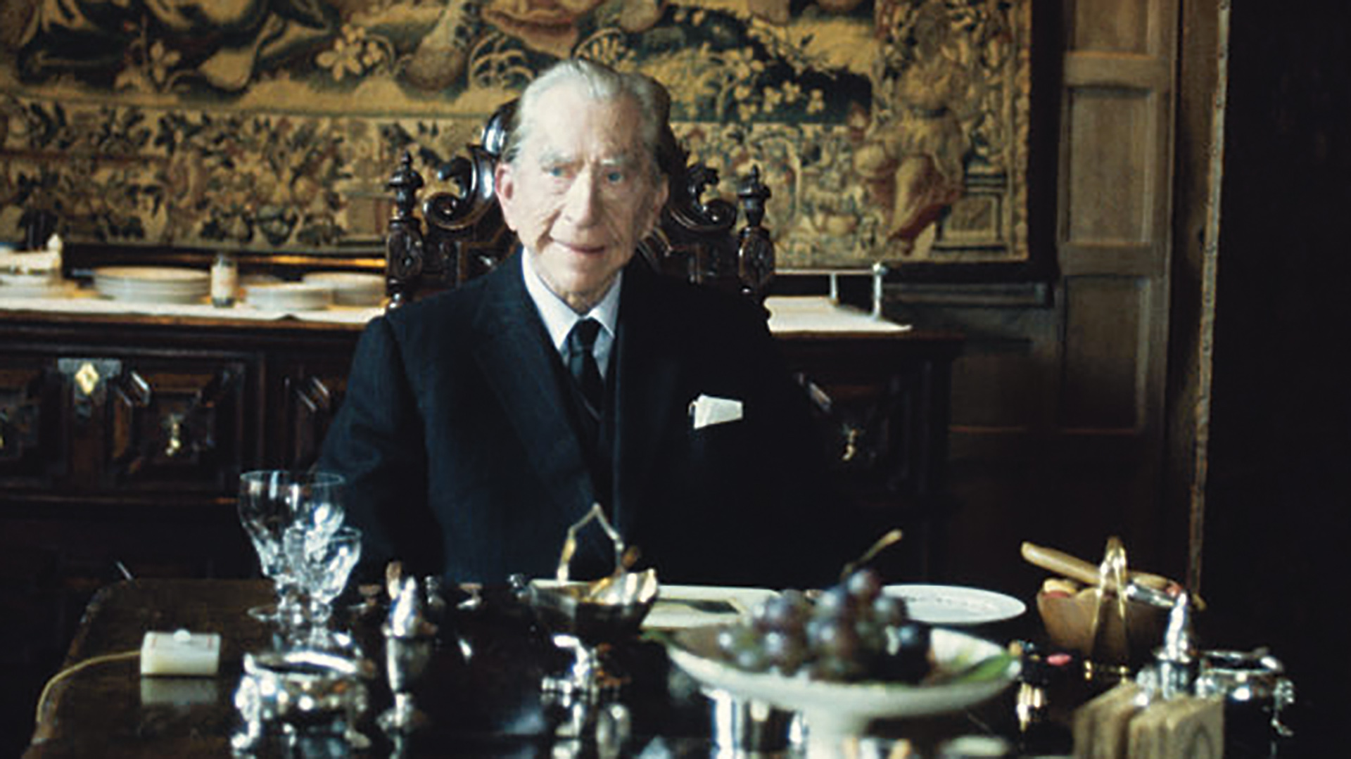 J Paul Getty sits at a dining table alone