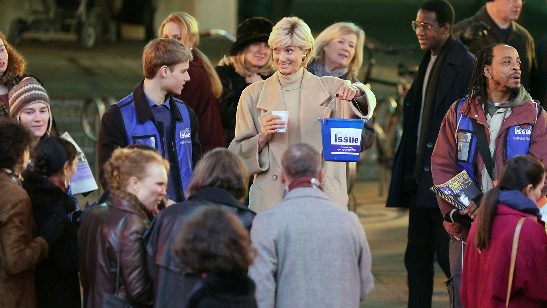 Elizabeth Debicki's Princess Diana and Rufus Kampa's Prince William filming for The Crown, selling The Big Issue outside a London underground station.