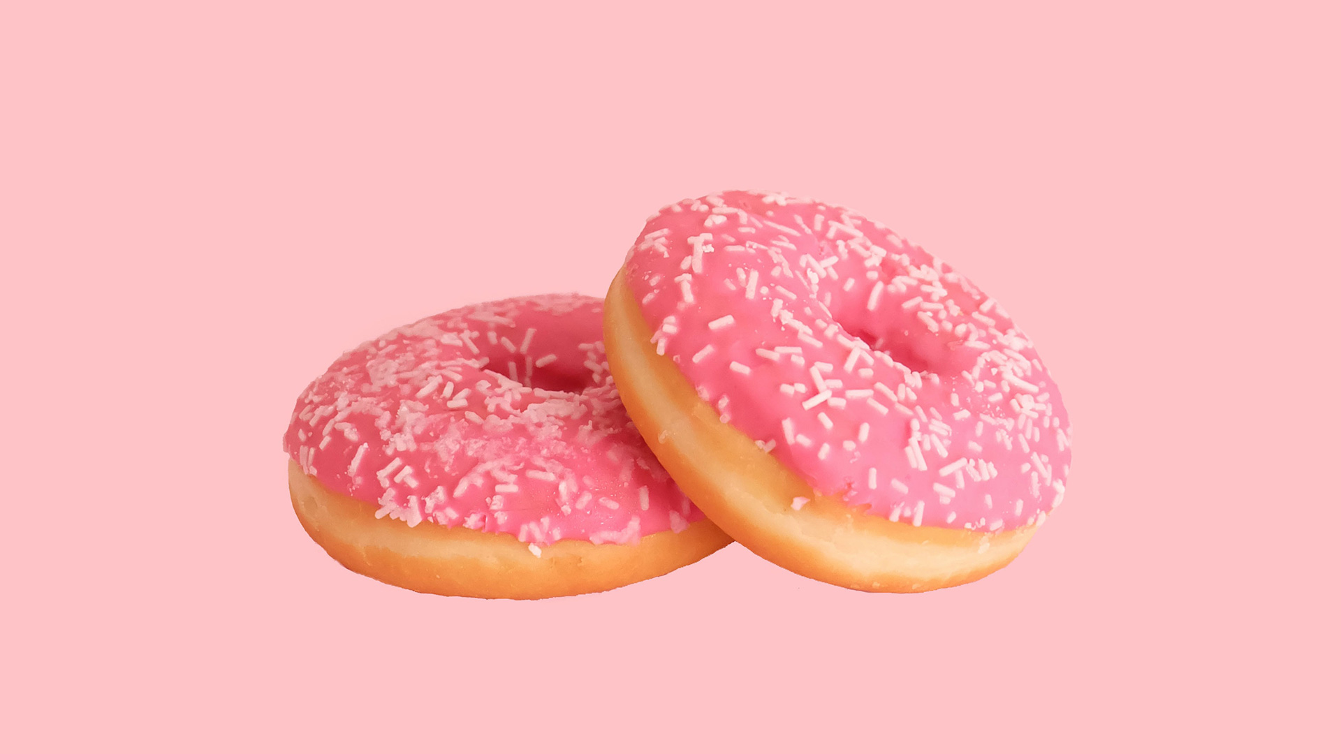 Two doughnuts with pink icing
