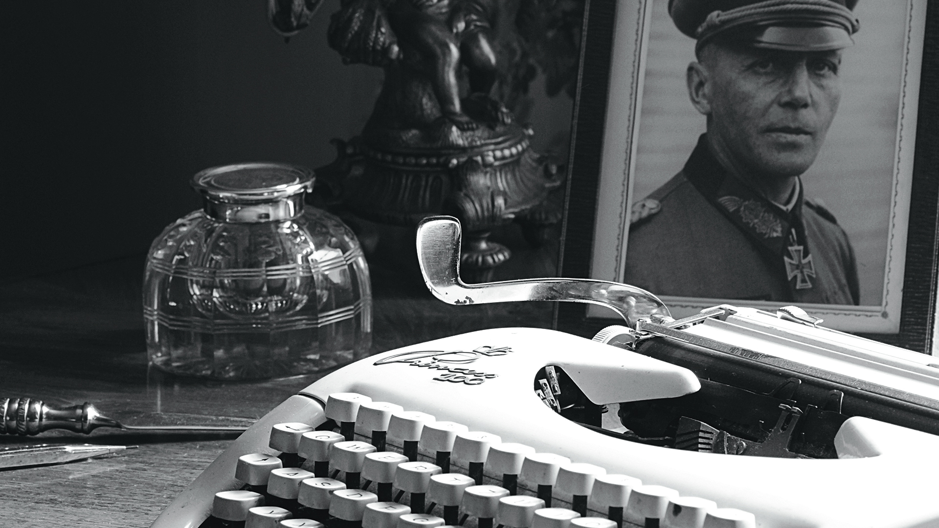A typewriter and a photo of a German in Nazi uniform