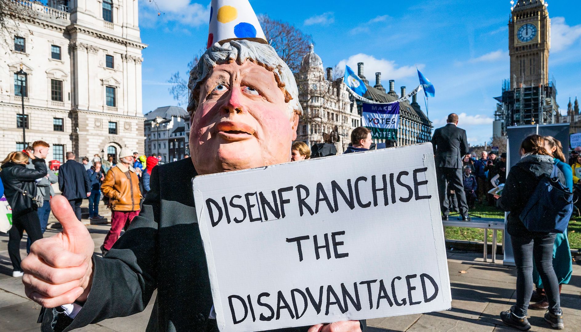 A caricature of Boris Johnson, Prime Minister, calls for the bill to 'Disenfranchise the disadvantaged' - Make votes matter - A Stop the Elections Bill Protest in Parliament Square.