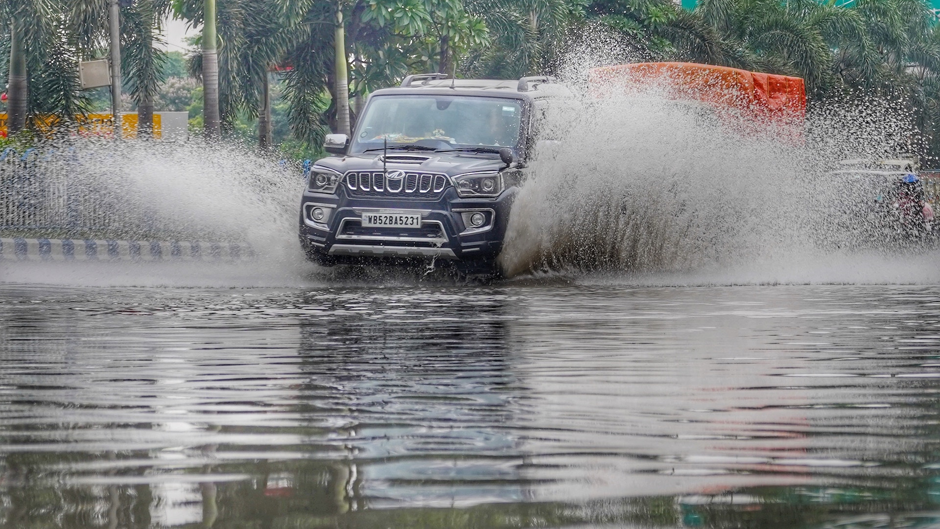 A jeep driving through a flood, induced by climate change