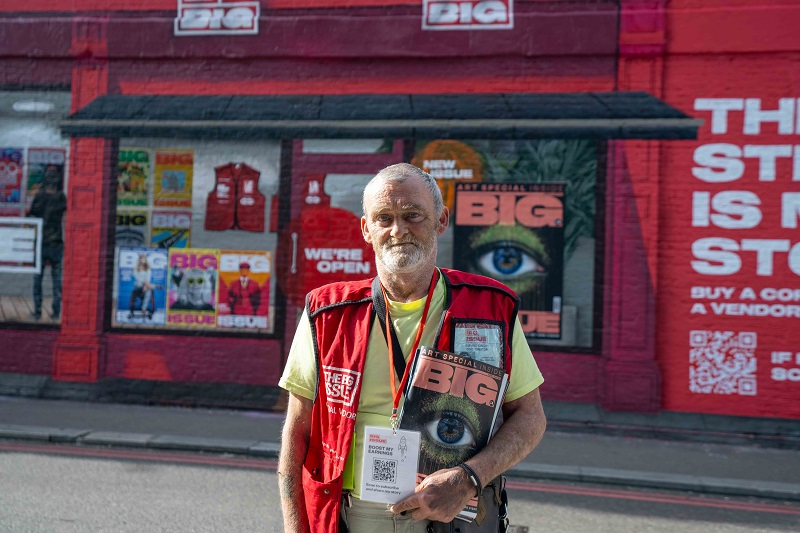 Big Issue seller Paul Logan at Big Issue mural in London