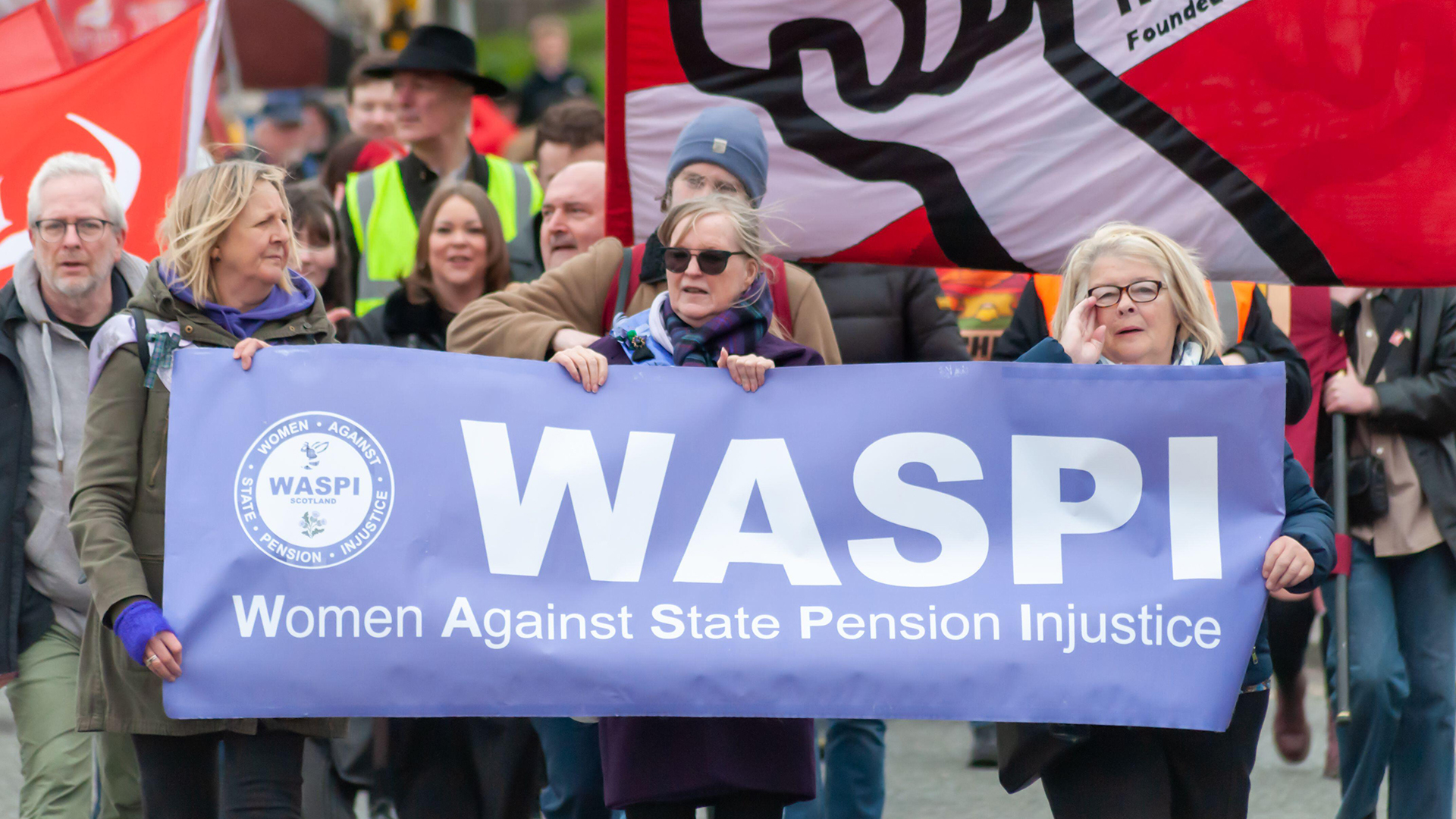 Women holding a WASPI banner