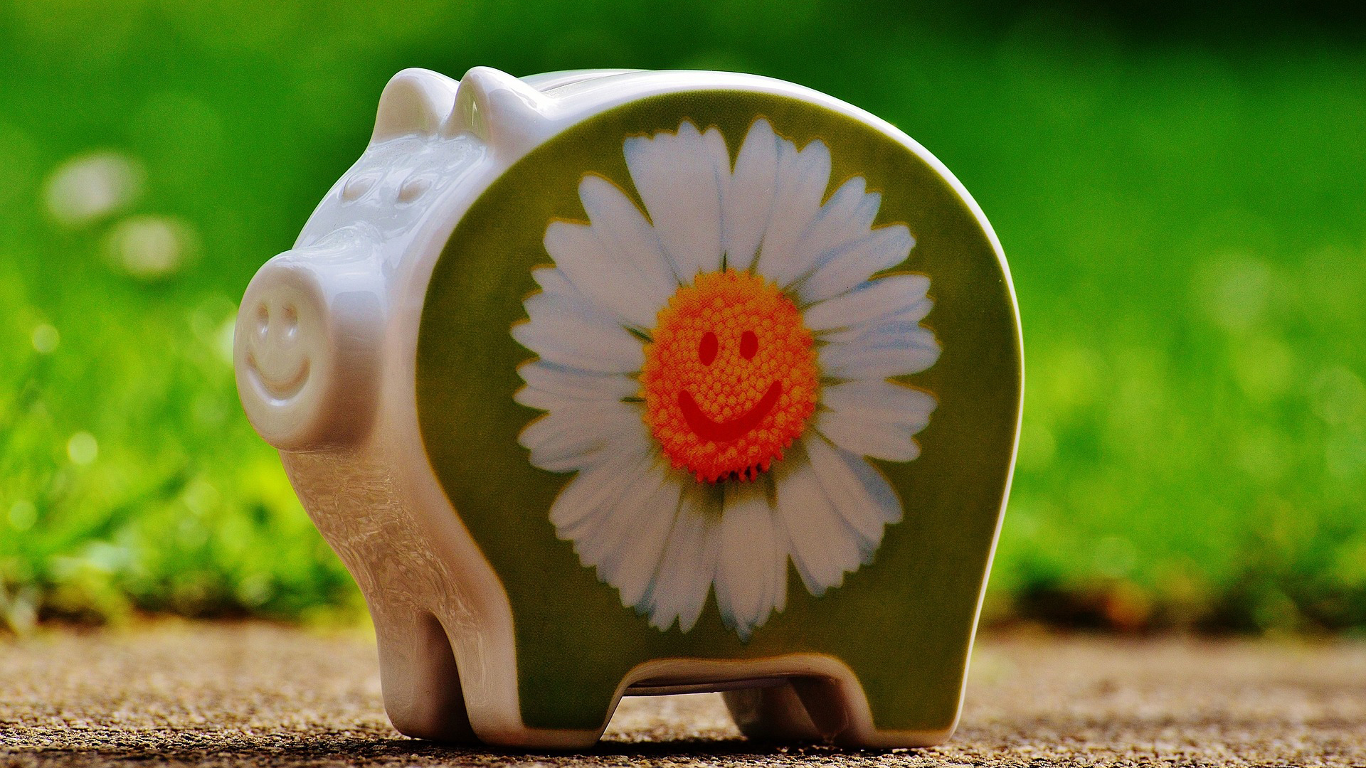 A piggy bank with a flower painted on it