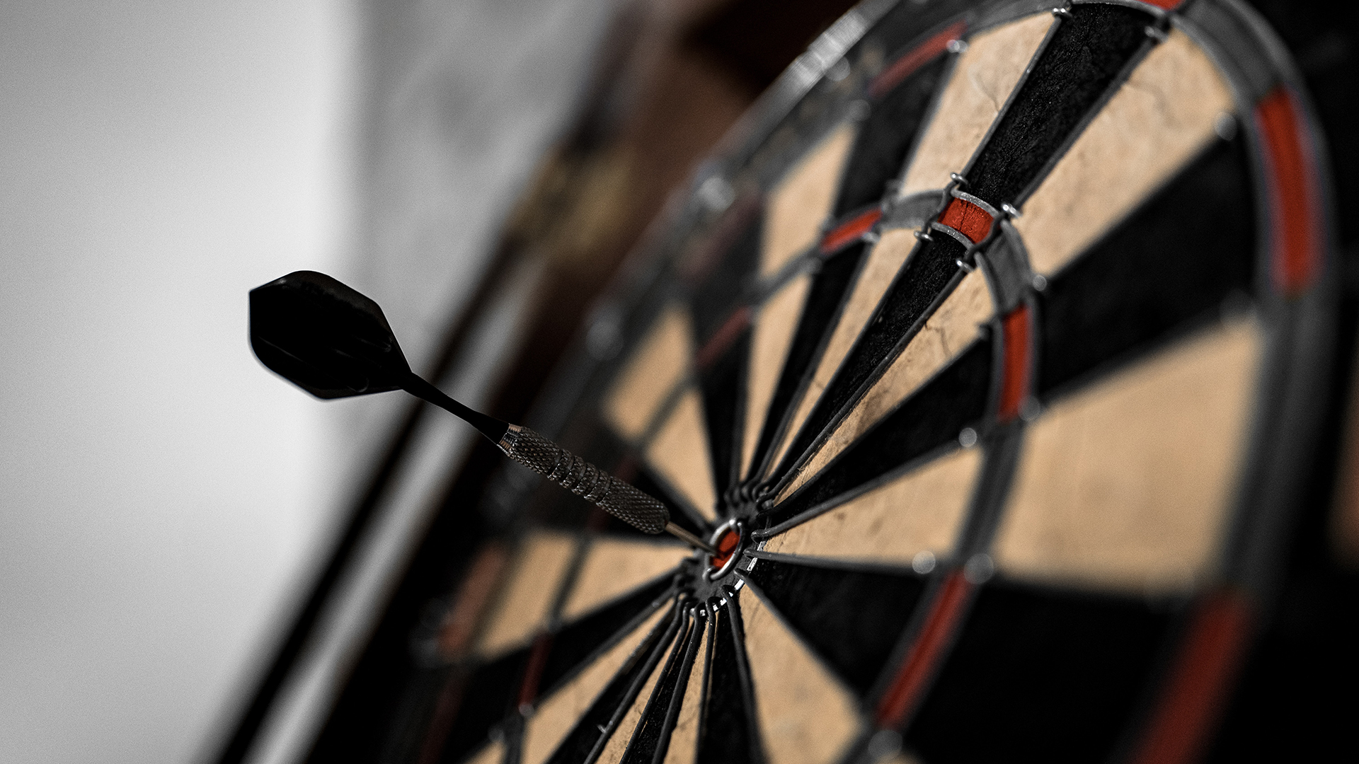 Close-up of a dartboard with a dart in the bullseye